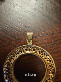 14k Yellow Gold 32.77mm Coin Opening Pendant. 13.15 grams of 14k gold