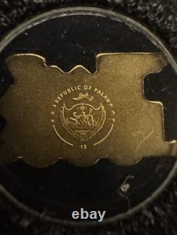 Palau Golden Train 0.5g Gold Coin (Shape of a Train) With Plastic Capsule
